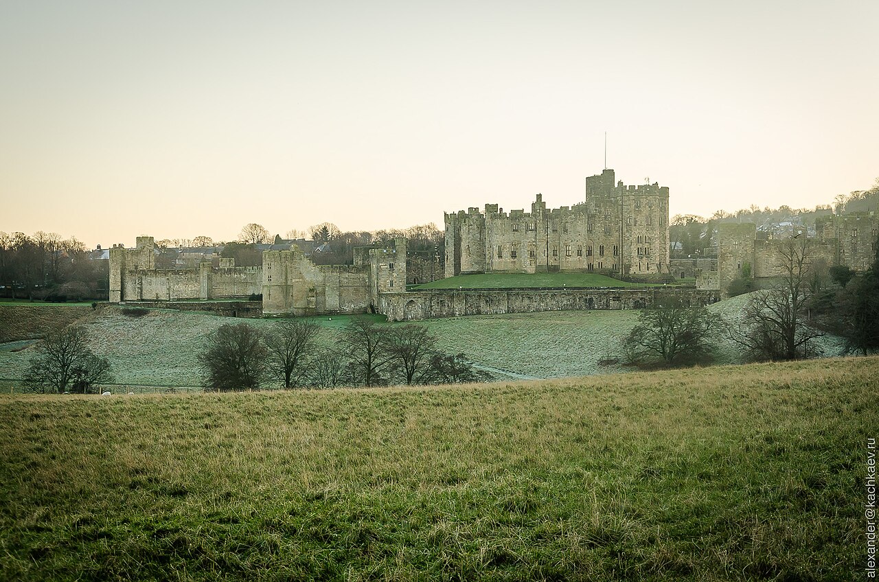 Alnwick Castle's walls and towers above the River Aln